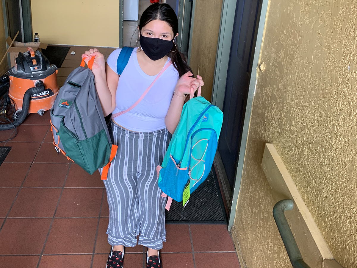 Talia delivering backpacks